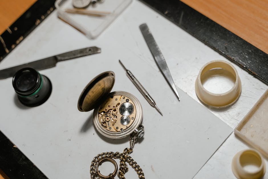 Detailed view of a vintage pocket watch with repair tools, showcasing precision craftsmanship.